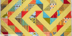 Finished yellow spiral quilt top