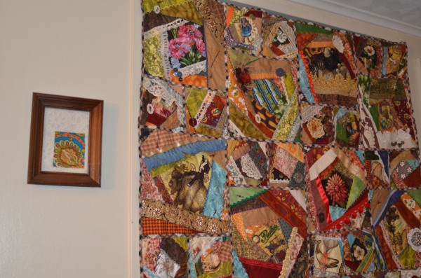 Steampunk crazy quilt hanging on wall