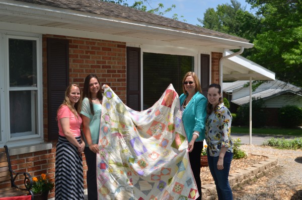 Mom, sisters and I with the quilt